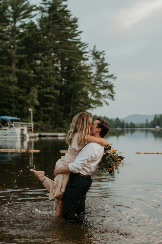 bride and groom swimming in lake