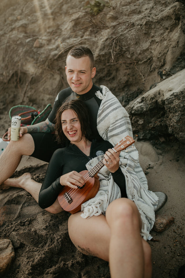 Beach elopement couple playing music 