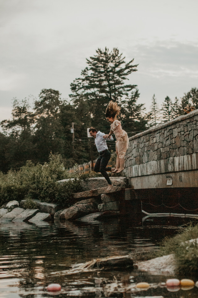 Lakeside elopement in the white mountains bride and groom jumping in the water
